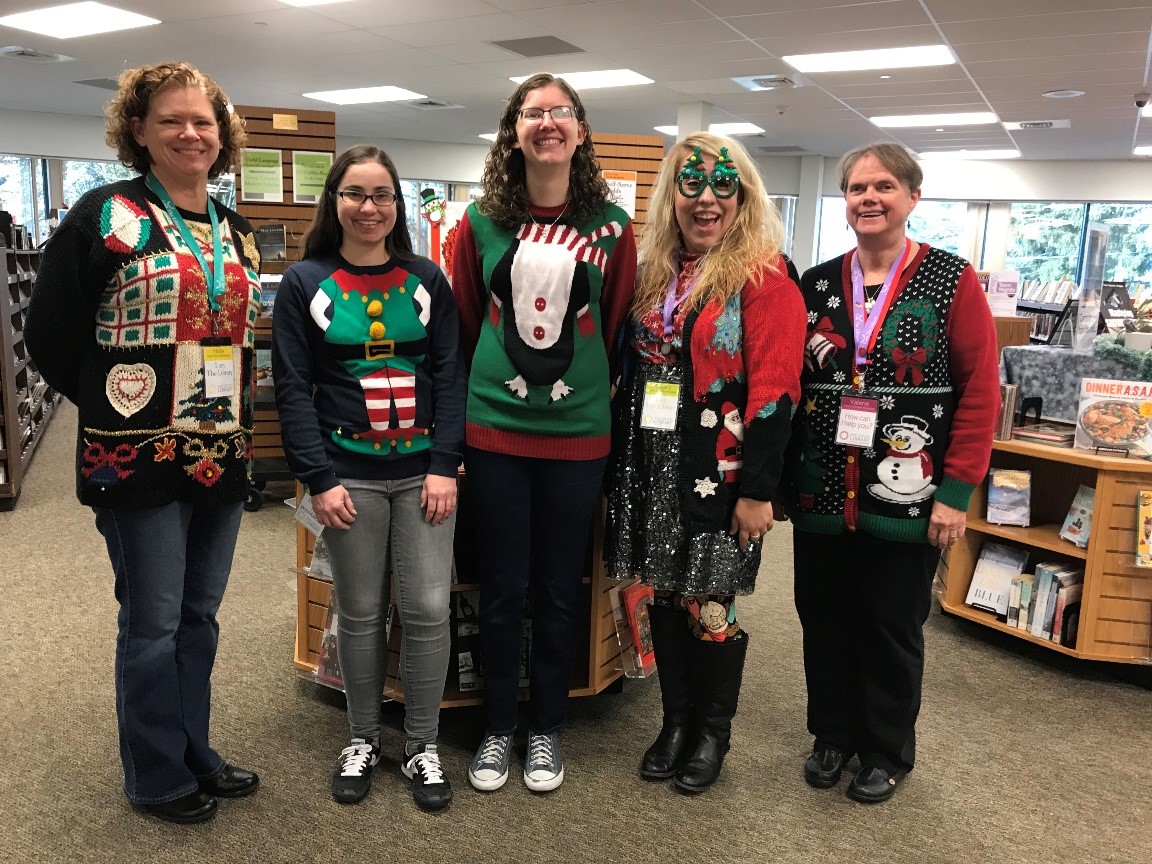 library staff gathered with their ugly sweaters